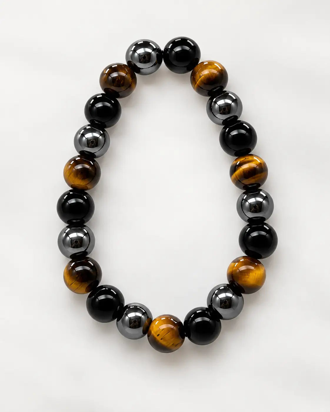 Classic Triple Protection bracelet with golden-brown, gunmetal and black beads on a white background